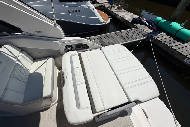 Slide: The Image of 2023 Regal 28 Express boat interior with white seating at dock. - 10