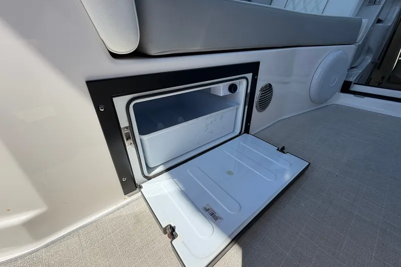 Slide: The Image of Open storage compartment on 2023 Regal 28 Express boat, featuring a sleek interior design. - 13
