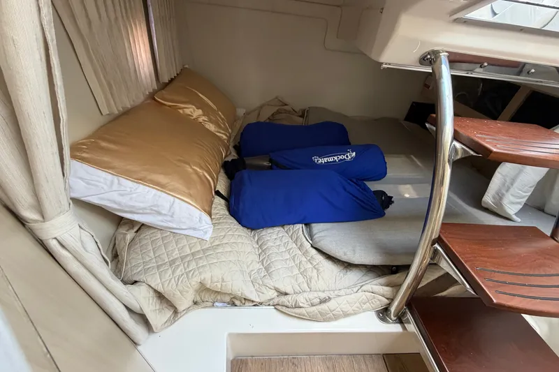 Slide: The Image of Cozy cabin interior of 2023 Regal 28 Express boat with bedding and cushions. - 28