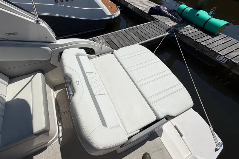 Slide: The Image of 2023 Regal 28 Express boat interior with white seating at dock. - 9