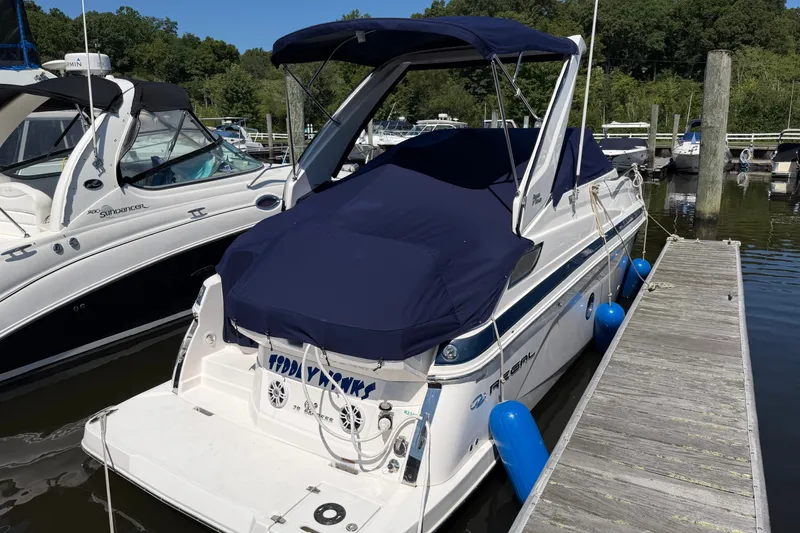 Slide: The Image of 2023 Regal 28 Express boat docked with blue cover and fenders. - 30