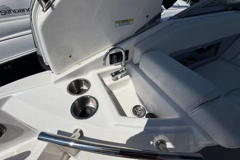 Slide: The Image of 2023 Regal 28 Express boat interior with sink and cup holders. - 12