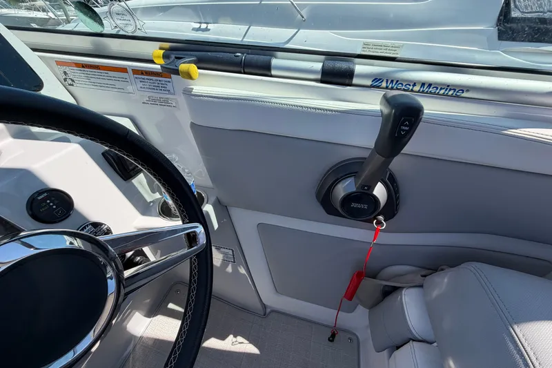 Slide: The Image of Interior view of 2023 Regal 28 Express boat cockpit with steering wheel and throttle controls. - 19
