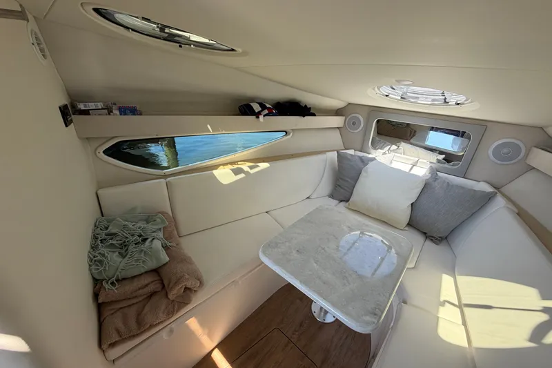 Slide: The Image of Cozy interior of 2023 Regal 28 Express boat with plush seating and table. - 24