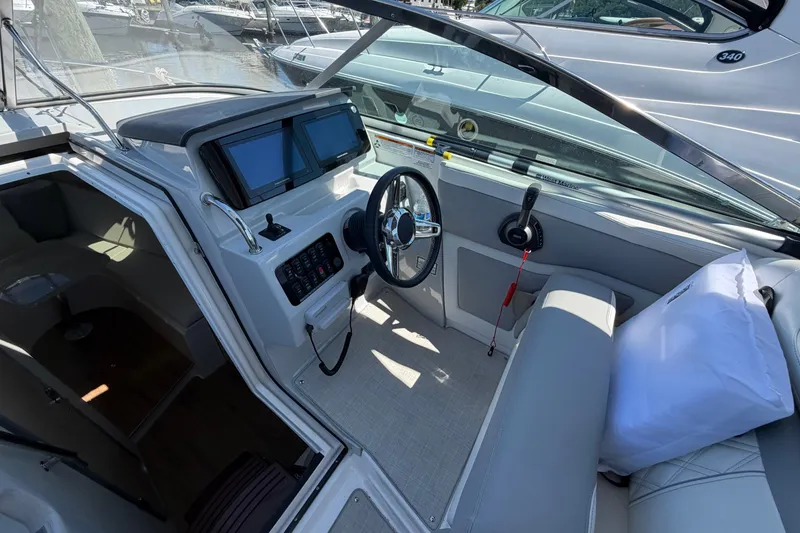 Slide: The Image of 2023 Regal 28 Express boat cockpit with modern controls and seating. - 16