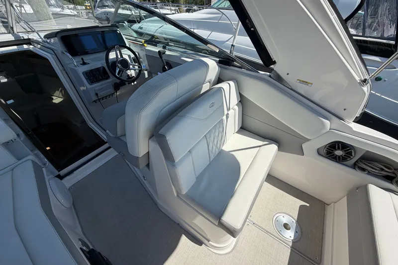 Slide: The Image of Interior of 2023 Regal 28 Express boat with modern seating and steering wheel. - 14