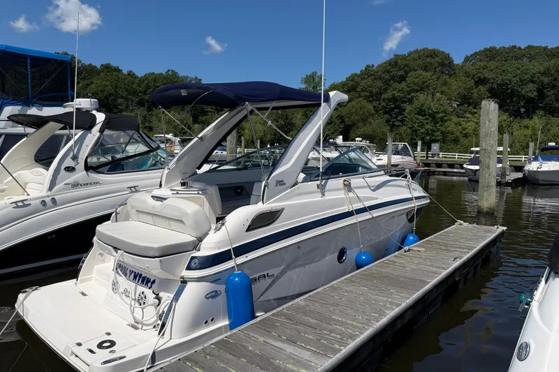Slide: The Image of 2023 Regal 28 Express boat docked at marina, featuring sleek design and blue canopy. - 5