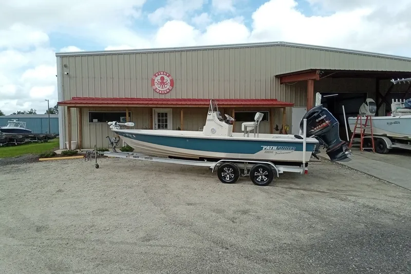 Slide: The Image of 2006 Pathfinder 2200 Tournament Edition boat on trailer outside a metal building. - 2