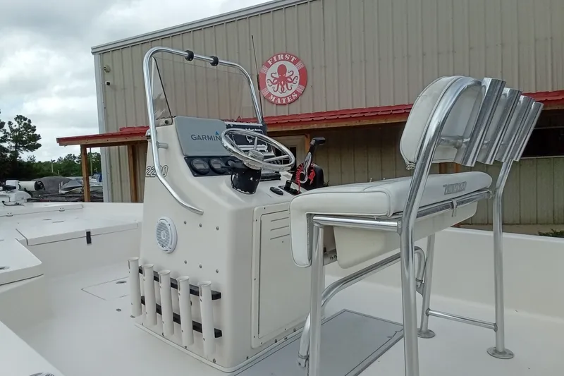 Slide: The Image of 2006 Pathfinder 2200 Tournament Edition boat with Garmin console, docked near a building. - 9
