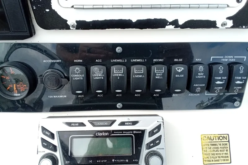 Slide: The Image of Control panel of a 2006 Pathfinder 2200 Tournament Edition boat with switches and gauges. - 26