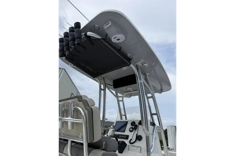 Slide: The Image of The image shows the helm of a Key West 239 FS boat with modern electronics and rod holders. - 4