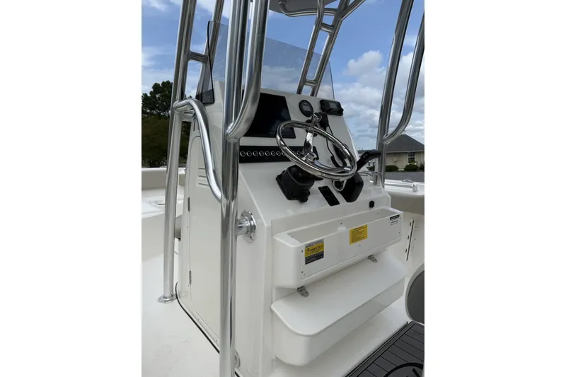 Slide: The Image of The image shows the helm of a Key West 239 FS boat with a steering wheel and instruments. - 6