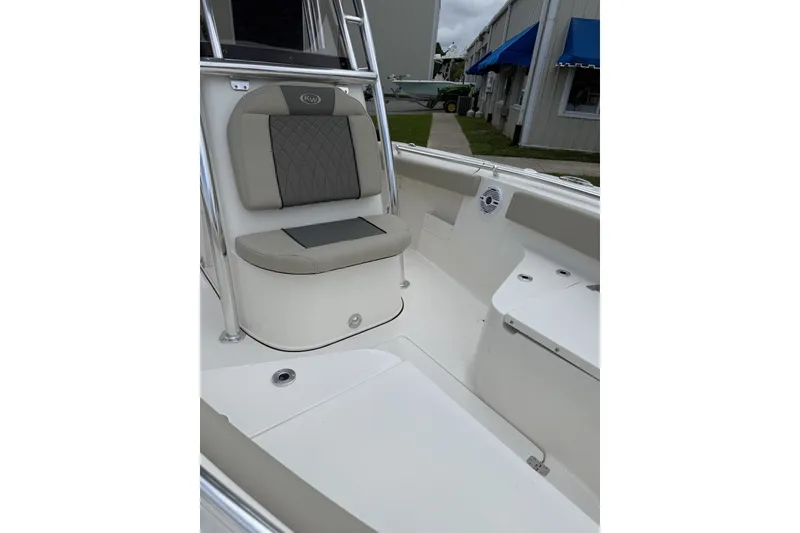Slide: The Image of The image shows the seating area of a Key West 239 FS boat. The upholstery is gray and beige. - 1