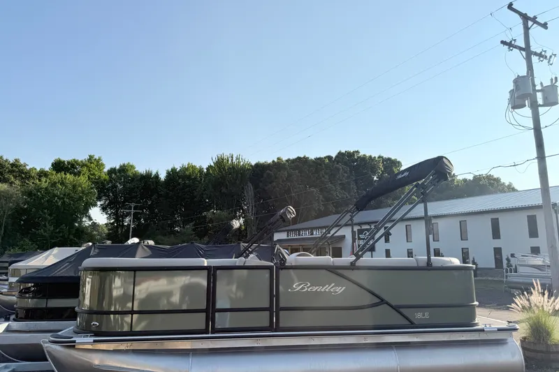 Slide: The Image of 2027 Bentley Pontoons LE 180CR pontoon boat parked outdoors under clear sky. - 3
