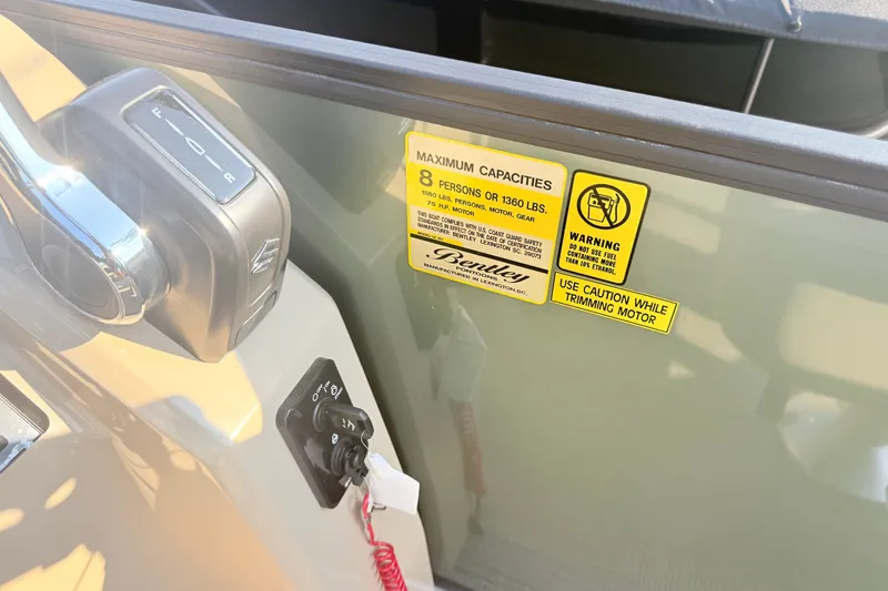 Slide: The Image of Control panel and capacity warning on 2027 Bentley Pontoons LE 180CR boat. - 5