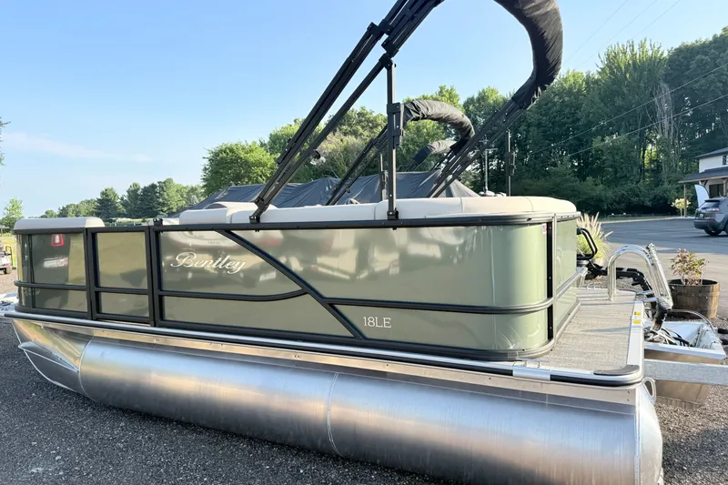 Slide: The Image of 2027 Bentley Pontoons LE 180CR pontoon boat parked outdoors on a sunny day. - 1