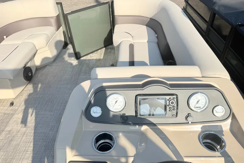 Slide: The Image of 2027 Bentley Pontoons LE 180CR interior with beige seating and control panel. - 12