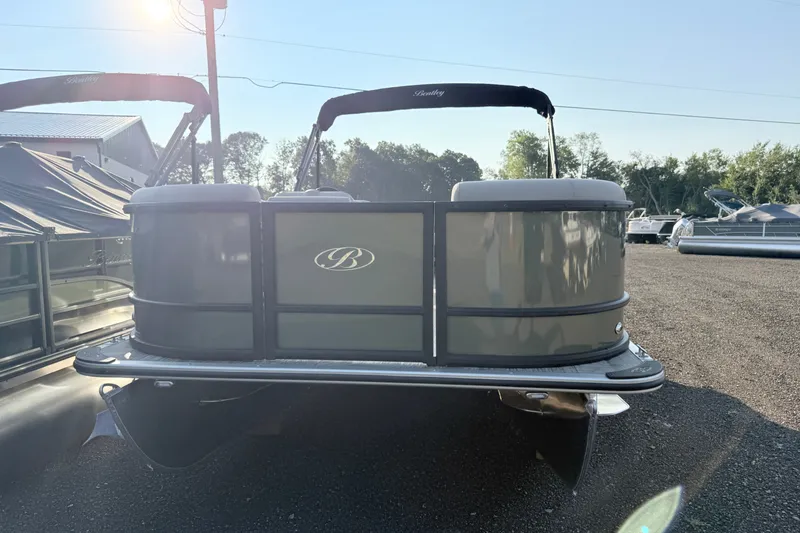 Slide: The Image of 2027 Bentley Pontoons LE 180CR pontoon boat in a sunny outdoor setting. - 6