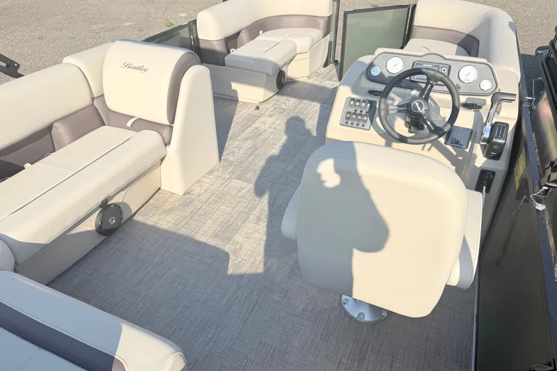 Slide: The Image of 2027 Bentley Pontoons LE 180CR interior with plush seating and modern helm controls. - 8