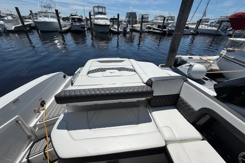 Slide: The Image of 2018 Monterey 298SS Super Sport boat docked at marina, featuring spacious seating and sleek design. - 12