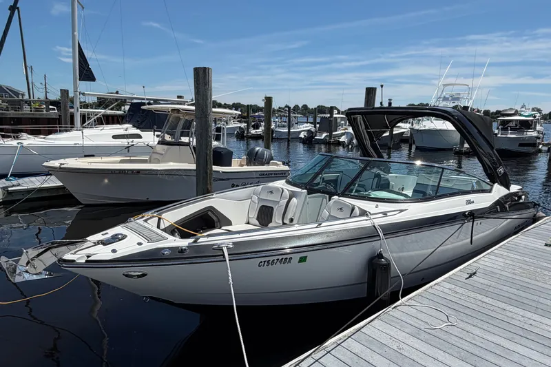 Slide: The Image of 2018 Monterey 298SS Super Sport boat docked at a marina under a clear blue sky. - 2