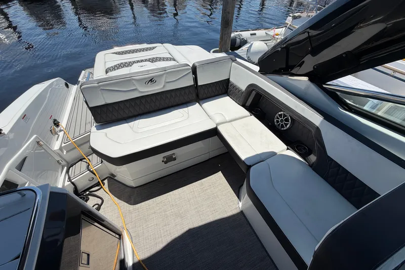 Slide: The Image of Luxurious seating area on a 2018 Monterey 298SS Super Sport boat by the water. - 11