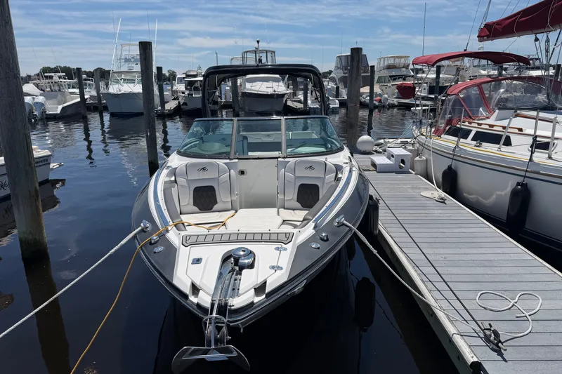 Slide: The Image of 2018 Monterey 298SS Super Sport boat docked at marina under clear sky. - 1