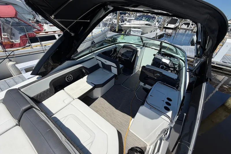 Slide: The Image of 2018 Monterey 298SS Super Sport boat interior at marina, featuring sleek seating and modern controls. - 10