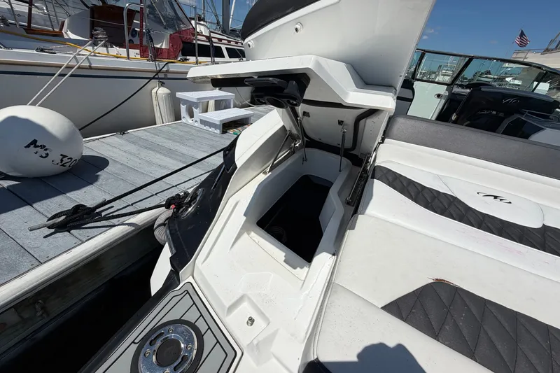 Slide: The Image of 2018 Monterey 298SS Super Sport boat with open storage compartment at dock. - 5