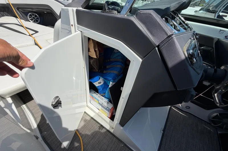 Slide: The Image of Storage compartment in a 2018 Monterey 298SS Super Sport boat, open with items inside. - 30