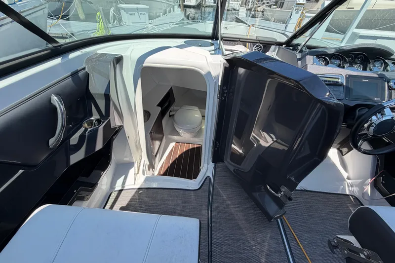 Slide: The Image of 2018 Monterey 298SS Super Sport boat interior with open cabin door and visible toilet. - 22