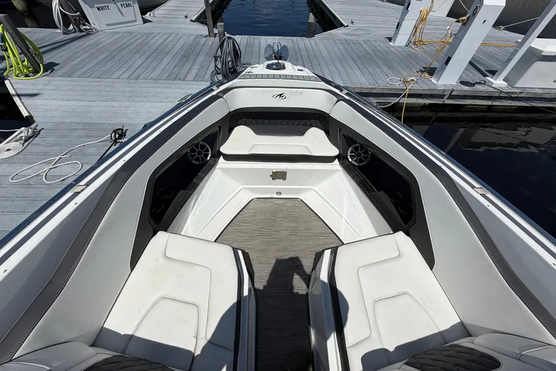 Slide: The Image of 2018 Monterey 298SS Super Sport boat interior with white seating at dock. - 34