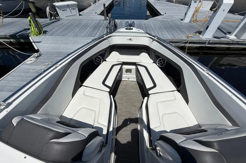 Slide: The Image of 2018 Monterey 298SS Super Sport boat interior with white seating at dock. - 33