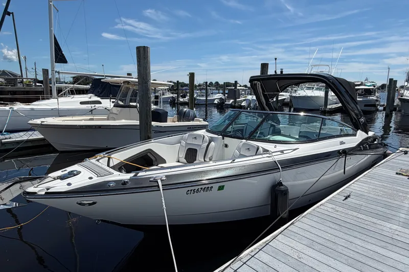 Slide: The Image of 2018 Monterey 298SS Super Sport boat docked at a marina under a clear blue sky. - 3