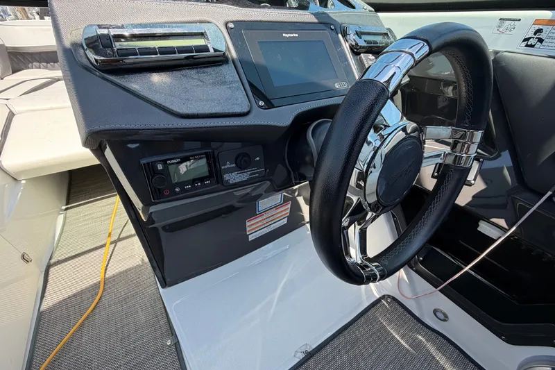 Slide: The Image of 2018 Monterey 298SS Super Sport boat dashboard with steering wheel and control panel. - 28
