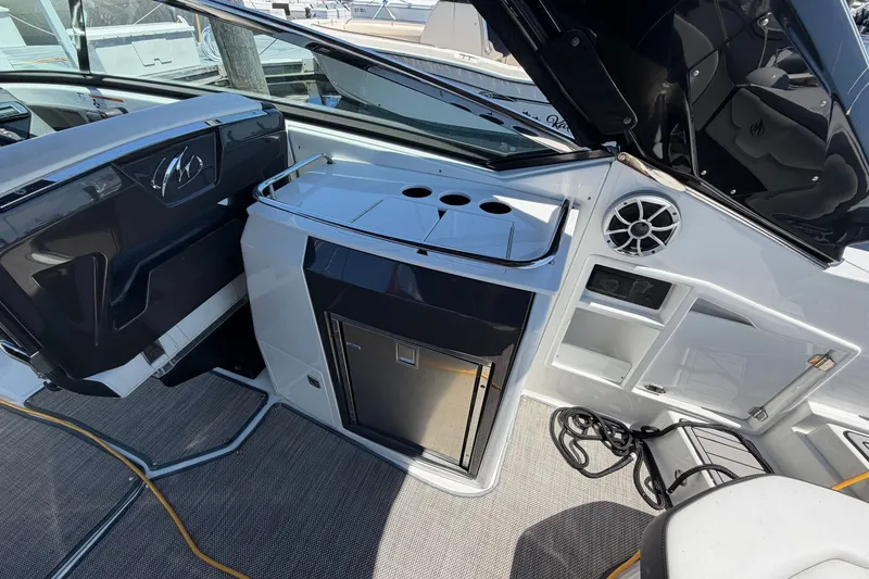 Slide: The Image of 2018 Monterey 298SS Super Sport boat interior with kitchenette and seating area. - 15