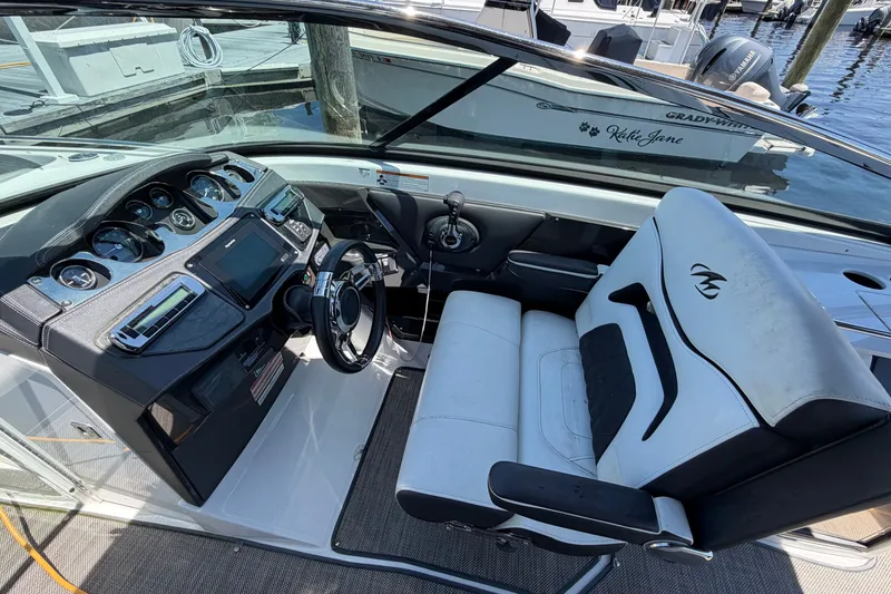 Slide: The Image of Cockpit of 2018 Monterey 298SS Super Sport boat with steering wheel and dashboard controls. - 26