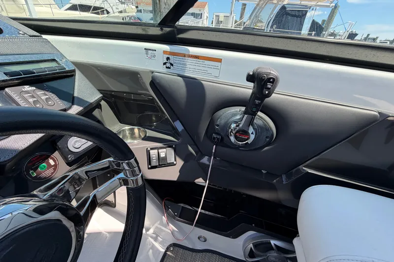 Slide: The Image of Interior view of a 2018 Monterey 298SS Super Sport boat cockpit with steering wheel and controls. - 29