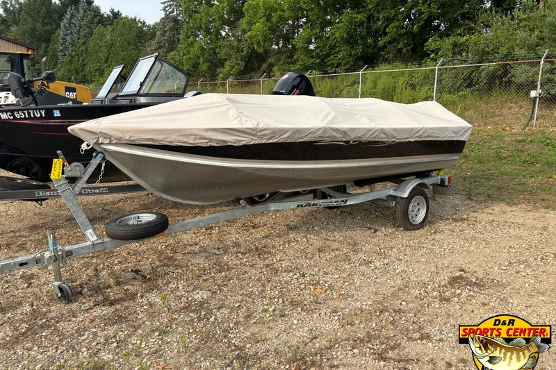 Slide: The Image of 2011 Lund WD 14 boat on trailer with cover, parked outdoors. - 6