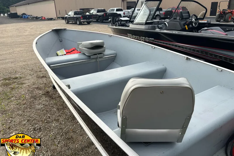 Slide: The Image of 2011 Lund WD 14 boat with seating, parked outdoors at D&R Sports Center. - 4