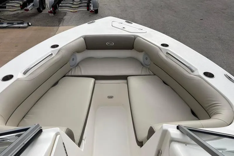 Slide: The Image of 2024 Key West 239 DFS boat interior with cushioned seating and cup holders. - 14