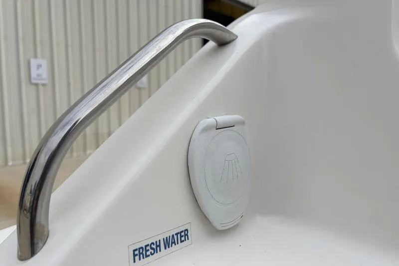 Slide: The Image of 2024 Key West 239 DFS boat detail showing fresh water access and stainless steel handle. - 32