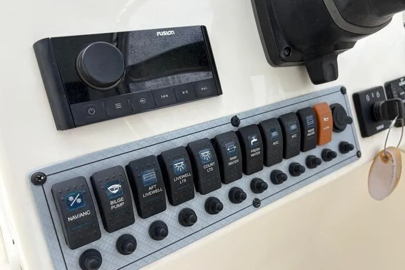 Slide: The Image of Control panel of 2024 Key West 239 DFS boat with switches and audio system. - 20