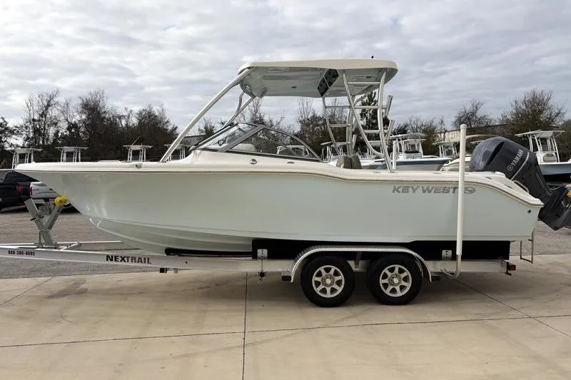 Slide: The Image of 2024 Key West 239 DFS boat on trailer, parked outdoors. - 4