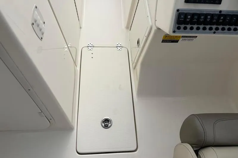 Slide: The Image of 2024 Key West 239 DFS boat interior with storage compartment and control panel. - 16