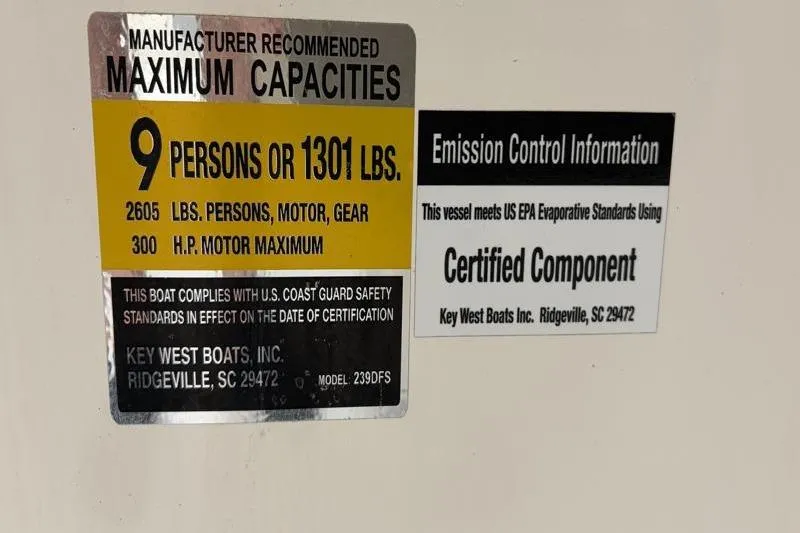Slide: The Image of 2024 Key West 239 DFS capacity and emission control labels, detailing weight and compliance standards. - 22