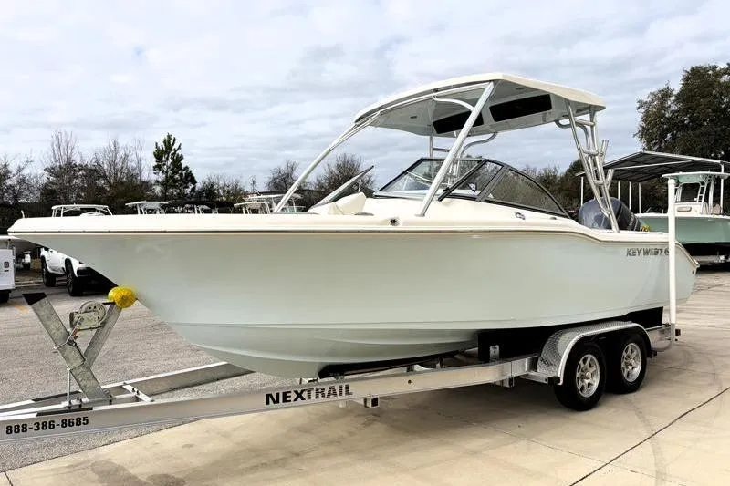 Slide: The Image of 2024 Key West 239 DFS boat on a Nextrail trailer, parked outdoors. - 3
