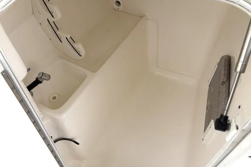 Slide: The Image of 2024 Key West 239 DFS boat interior storage compartment, featuring clean white finish. - 24