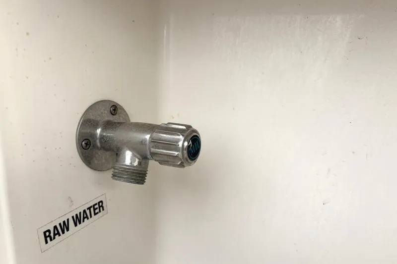 Slide: The Image of Raw water outlet on 2024 Key West 239 DFS boat, featuring a metal valve. - 30
