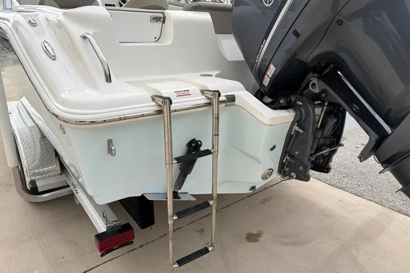 Slide: The Image of 2024 Key West 239 DFS boat with ladder and outboard motor, rear view. - 11